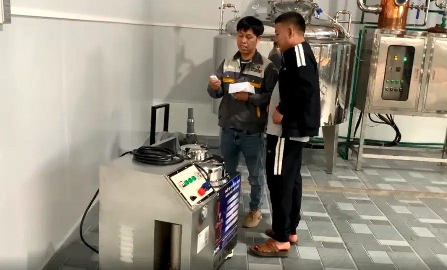 Nhân viên thái an hướng dẫn khách hàng sử dụng máy lão hóa rượu